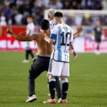 Lionel Messi tried to sign pitch invader's bare back after scoring 90th Argentina goal